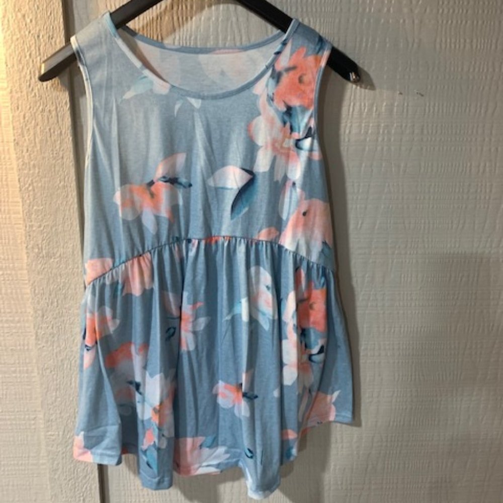 Women's sky blue, white, and orange tank top with a peplum bottom.